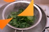 spinach steaming over a pasta pot