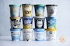 12 pints of different vegan vanilla ice cream brands stacked 3 pints high, 4 pints wide