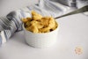 Upton's Naturals Deluxe Ch'eesy Bacon Mac in a ramekin with a spoon