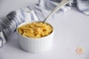 Follow Your Heart Cheezy Carrot Super Mac in a small bowl with a spoon