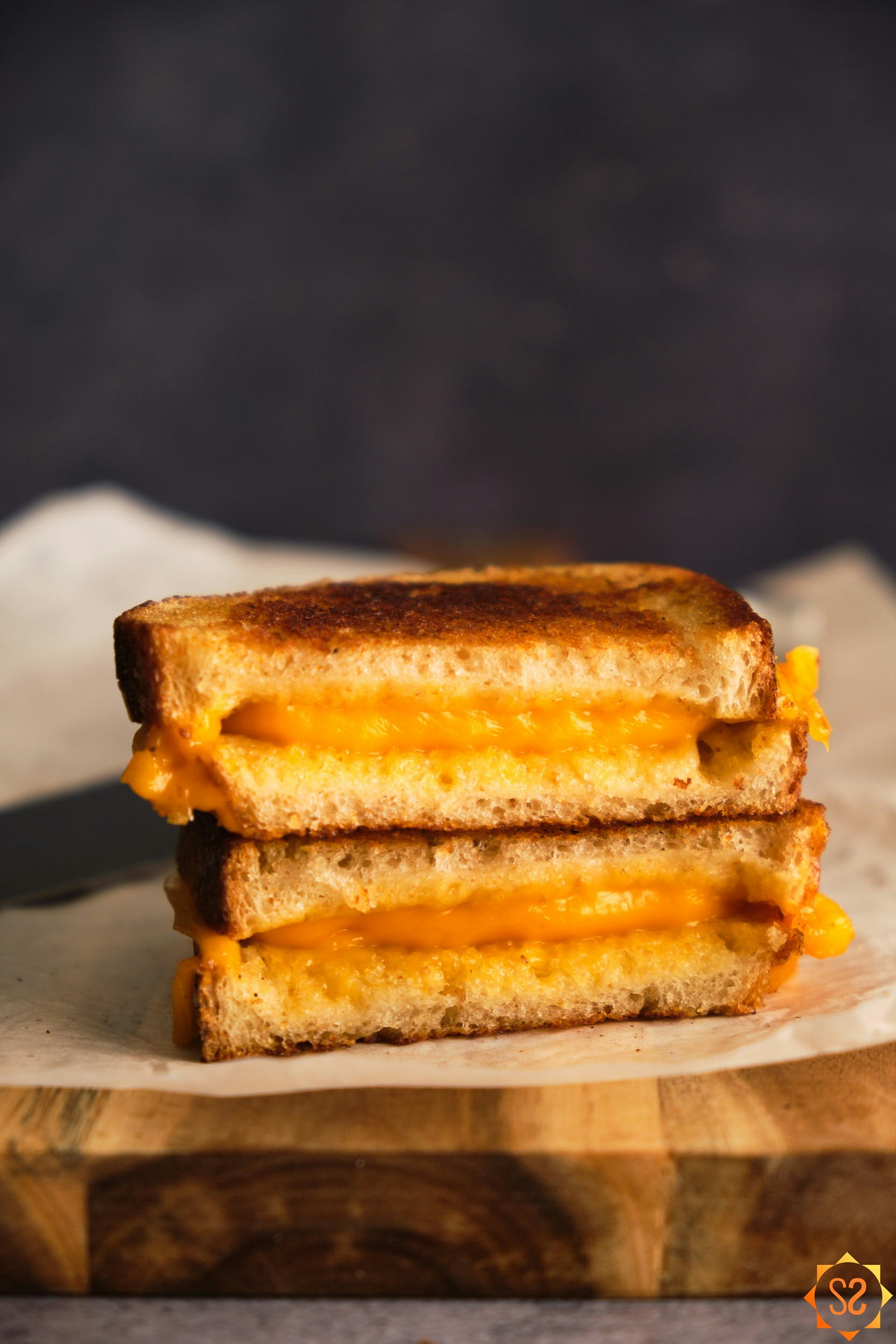 A side view of a grilled cheese sandwich made with Follow Your Heart American, stacked