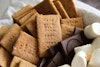 Graham crackers, chocolate, and marshmallows in a basket