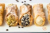 A close-up side view of vegan cannoli on a platter.