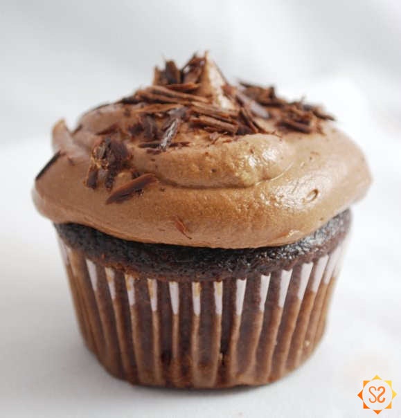 A chocolate cupcake with chocolate frosting
