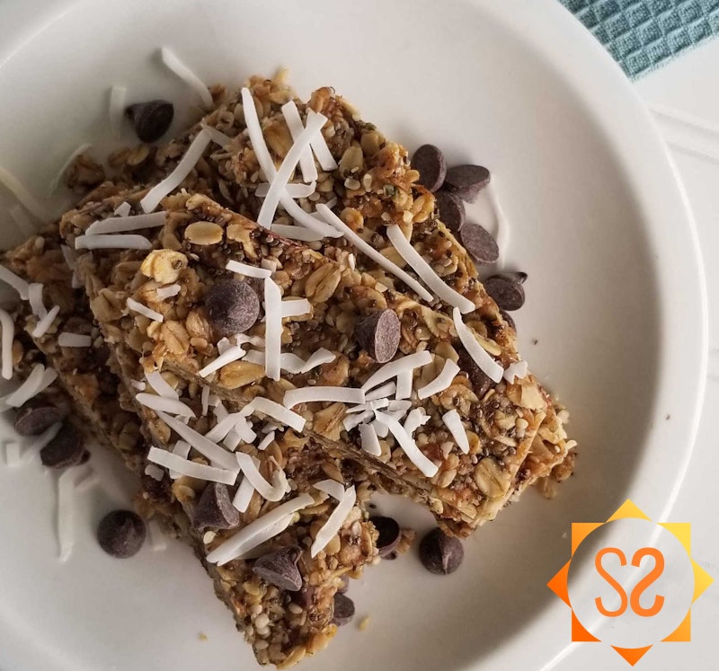 Chocolate peanut butter granola bars with coconut and chocolate chips on top