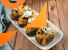 A platter of loaded vegan baked potatoes on a wooden table