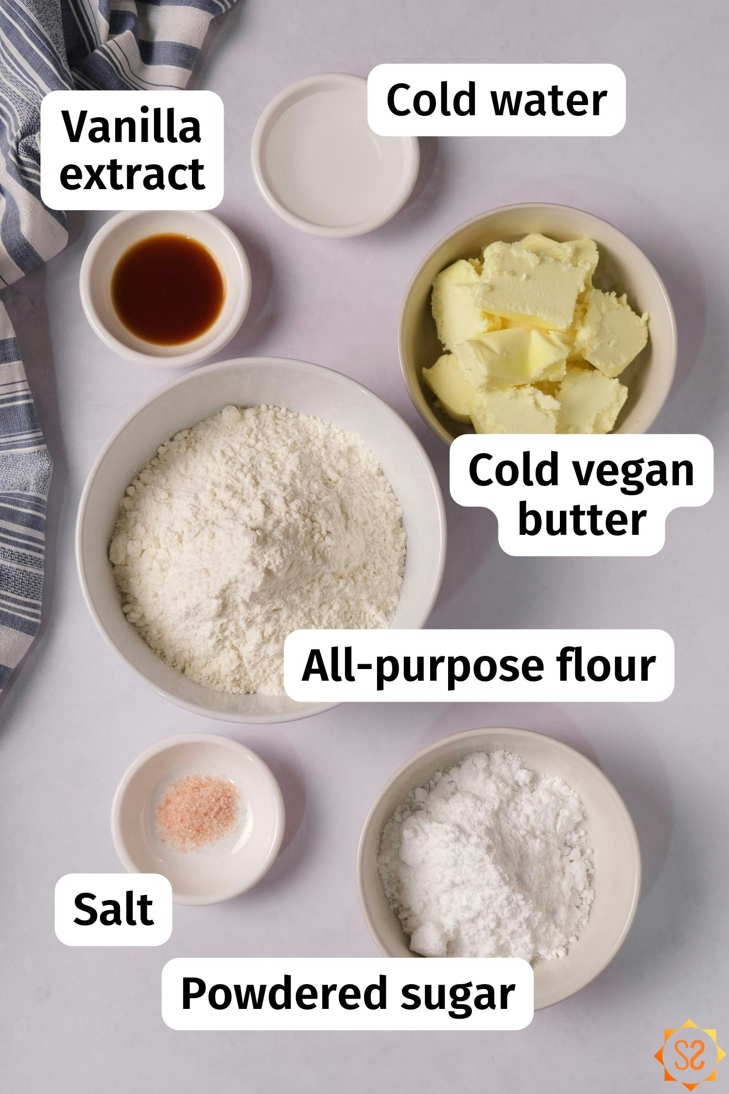 Ingredients for vegan pate brisee: all-purpose flour, cold vegan butter, cold water, powdered sugar, vanilla extract, and salt.