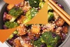 A close-up view of tofu stir fry in a bowl. 
