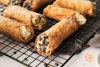 A closeup view of cannoli on a cooling rack