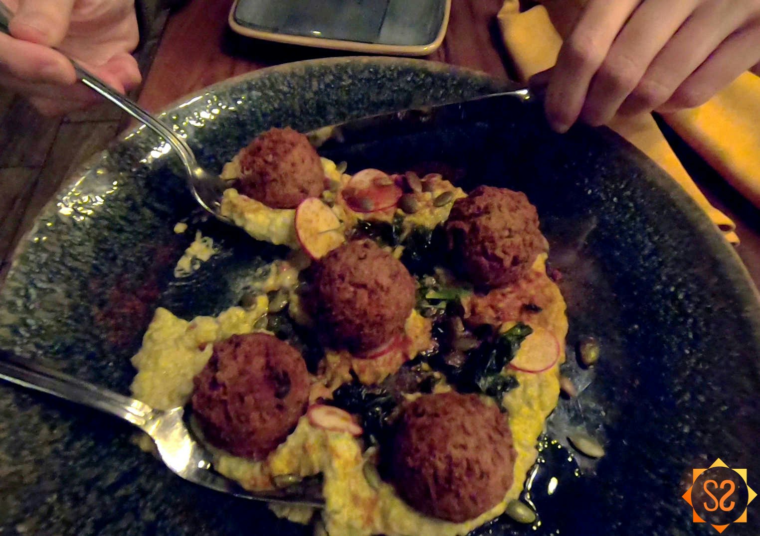 Falls Family Falafel on a plate, one piece being scooped out by a fork