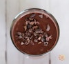 Chocolate açaí smoothie topped with cacao nibs