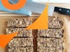 Granola bars cut up on a cutting board with a knife