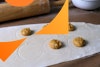 Rolled ravioli dough with marked circles and dollops of vegan butternut squash ravioli filling