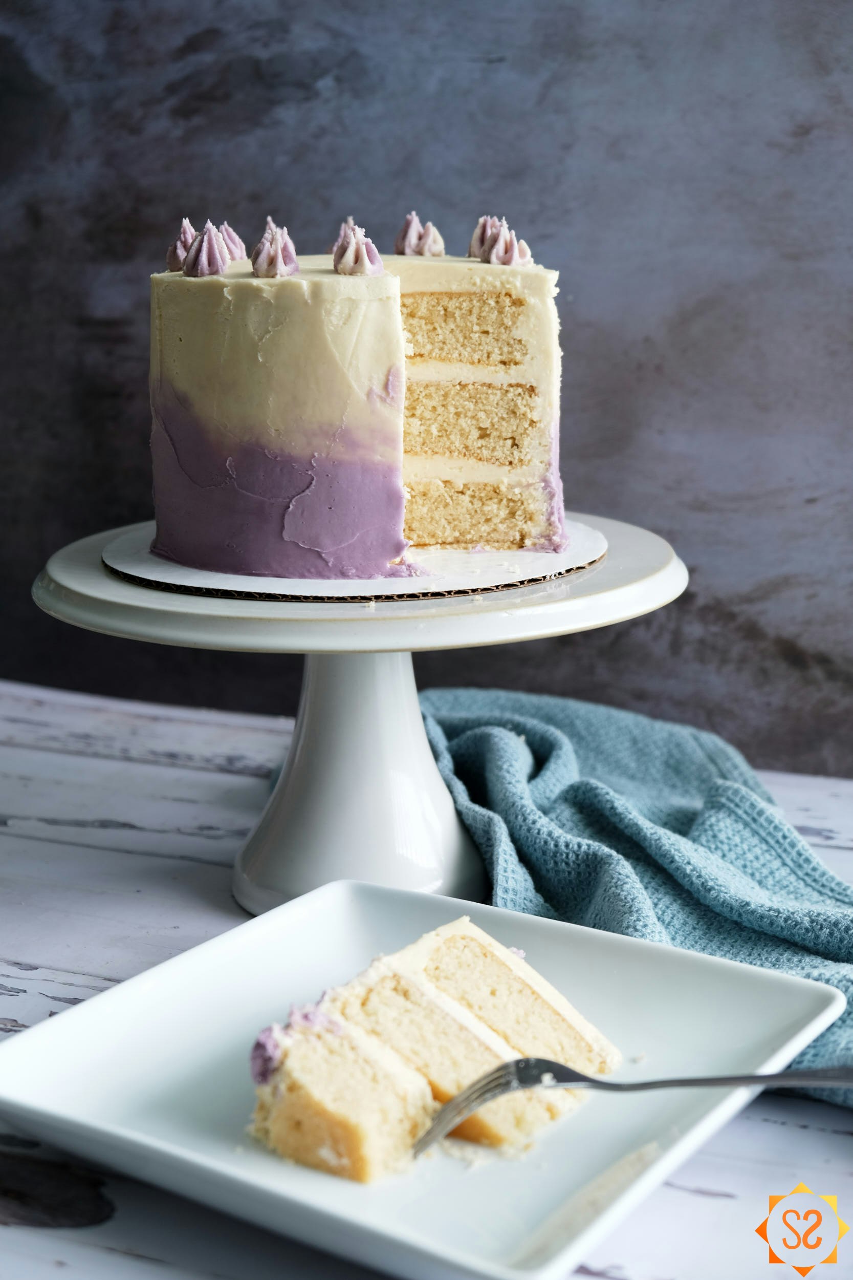vegan vanilla cake with slice in foreground