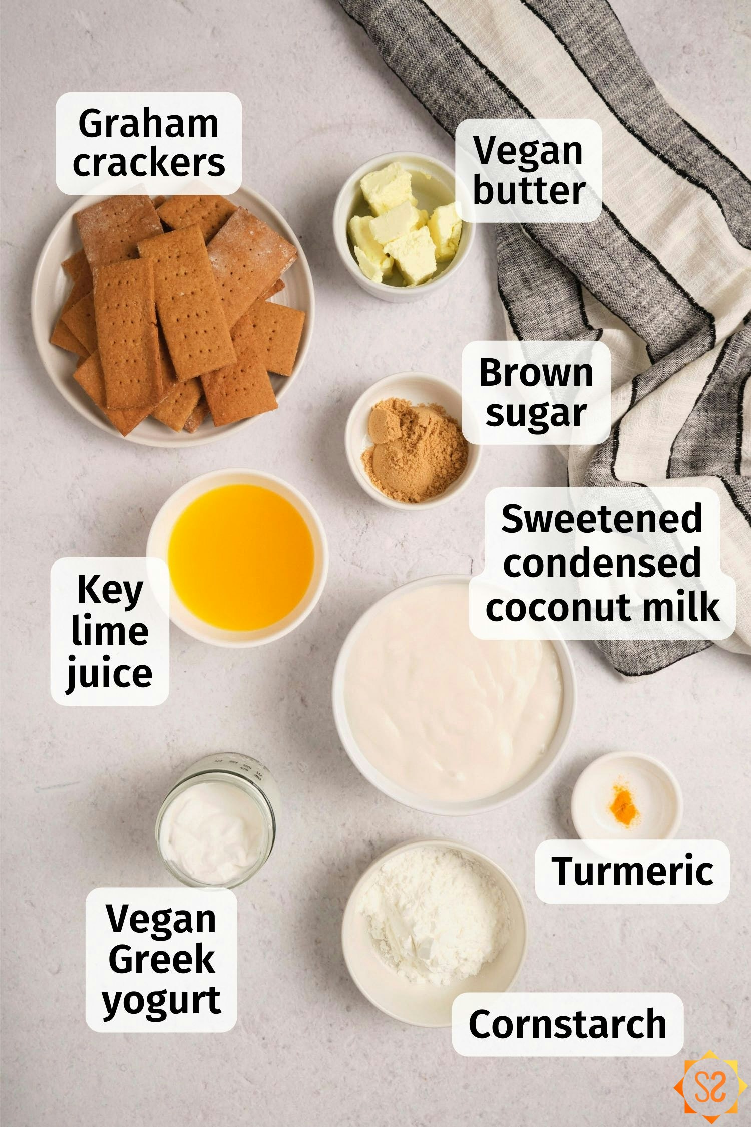A top down view of vegan Key lime pie ingredients in dishes, each labeled.