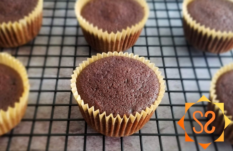 Chocolate cupcakes on a cooling rack
