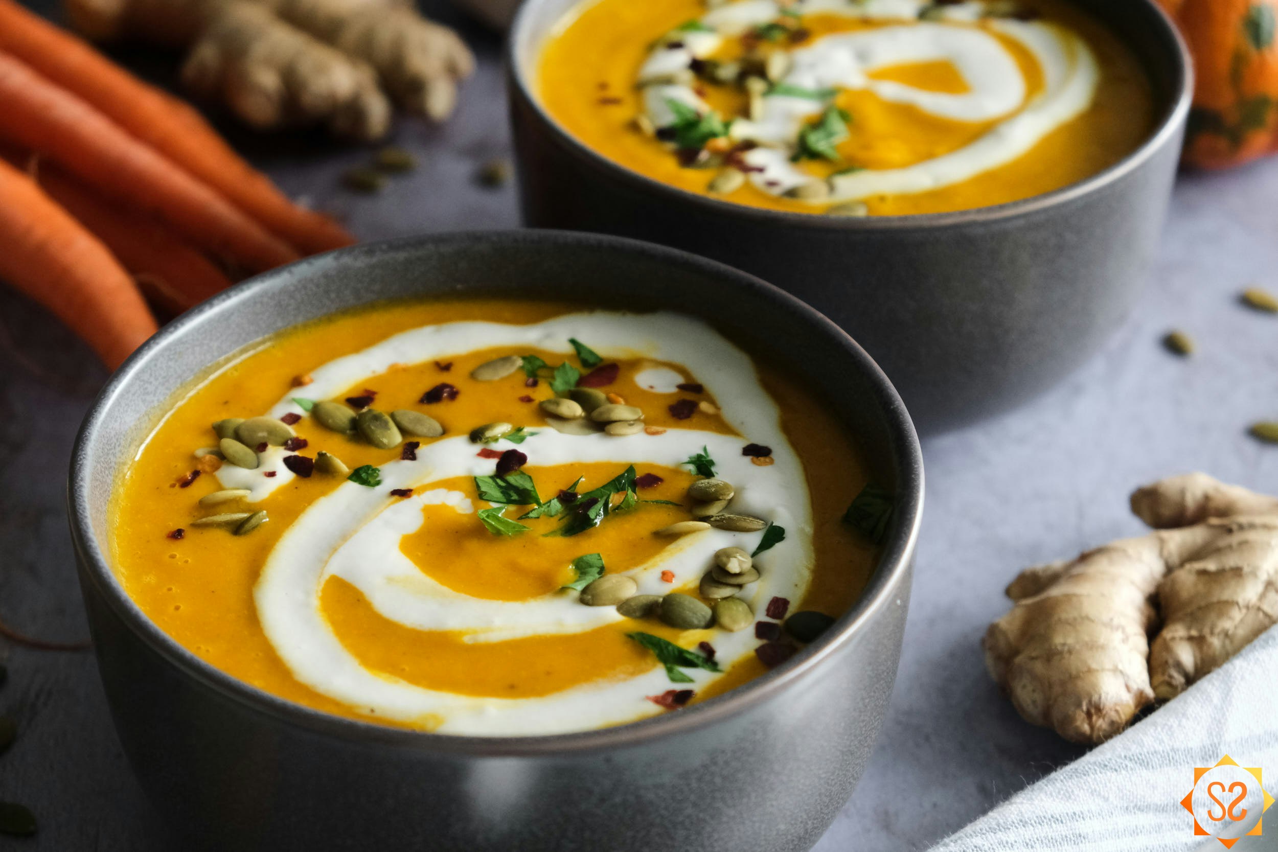 Carrot and pumpkin soup in a bowl.