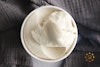 A top-down view of O'My Vanilla Bean Non-Dairy Gelato in its package, with a scoop on top.