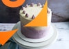 A 45 degree view of a vegan vanilla cake with buttercream frosting.