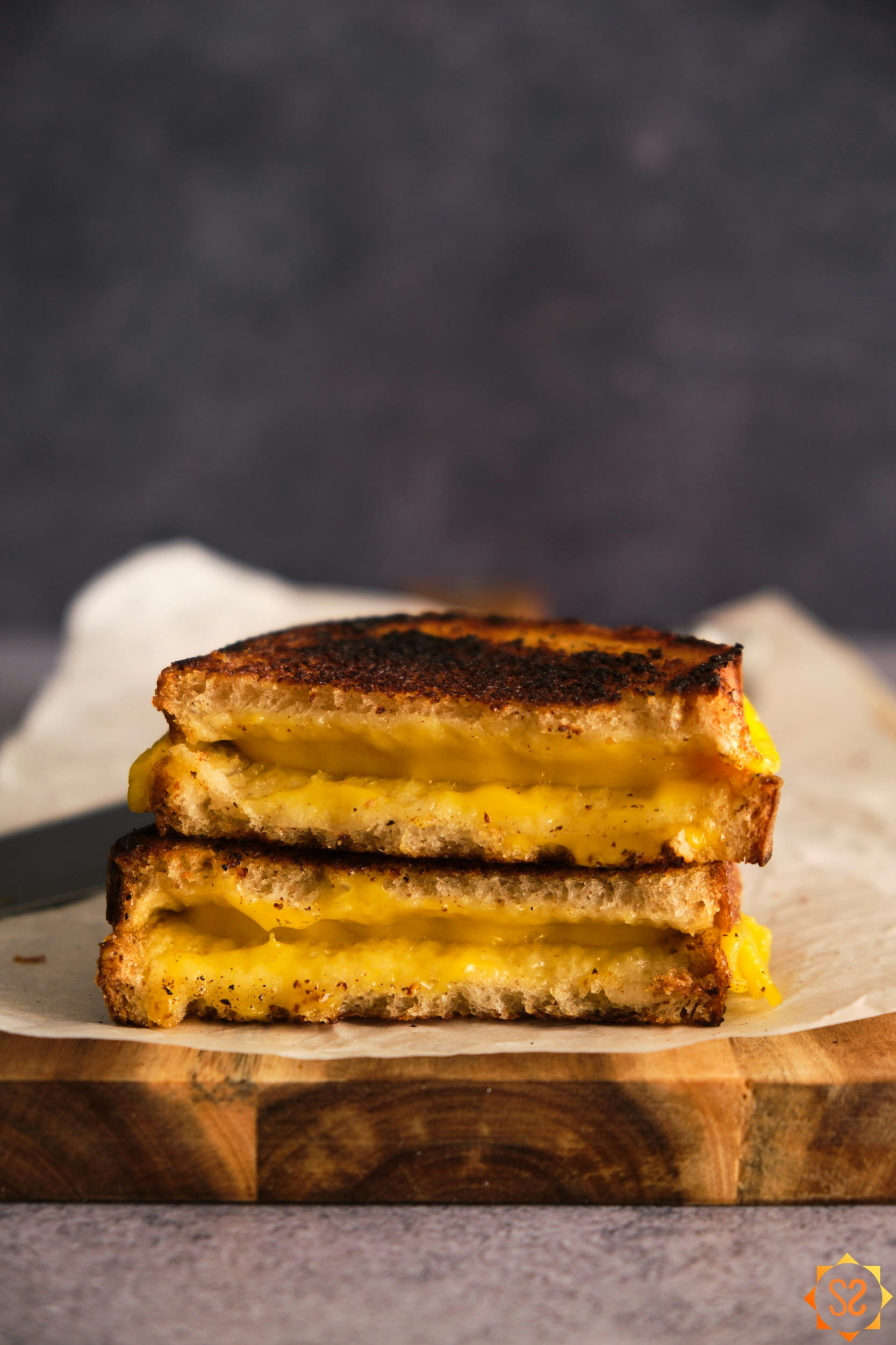 A side view of a grilled cheese sandwich made with Violife Mature Cheddar, stacked