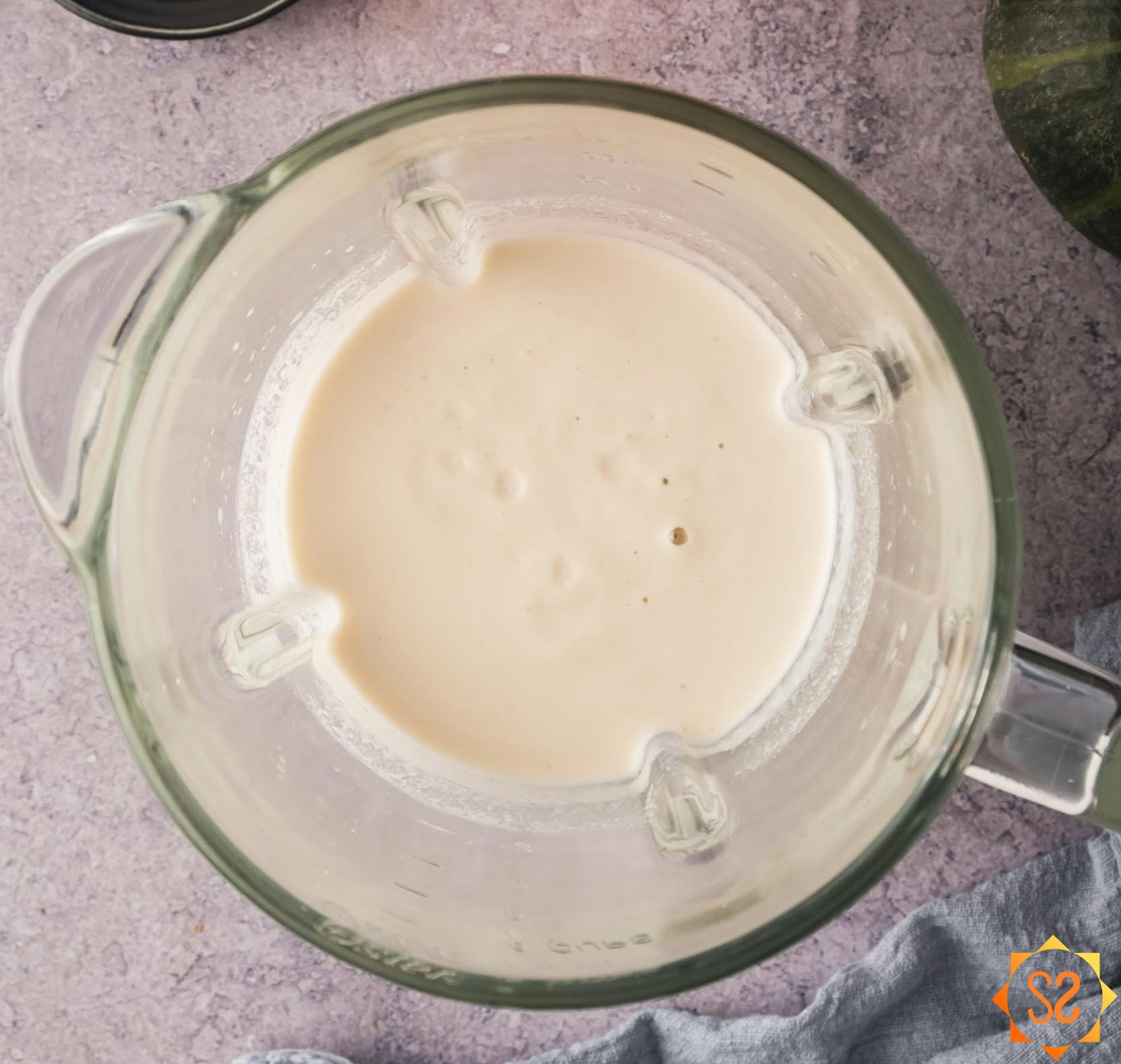 Blended cashew cream in a blender.