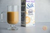 Silk Oat Creamer mixed with coffee in a mug