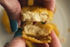A Like Meat Like Chick'n Nugget torn in half to show the texture of the vegan chicken inside.