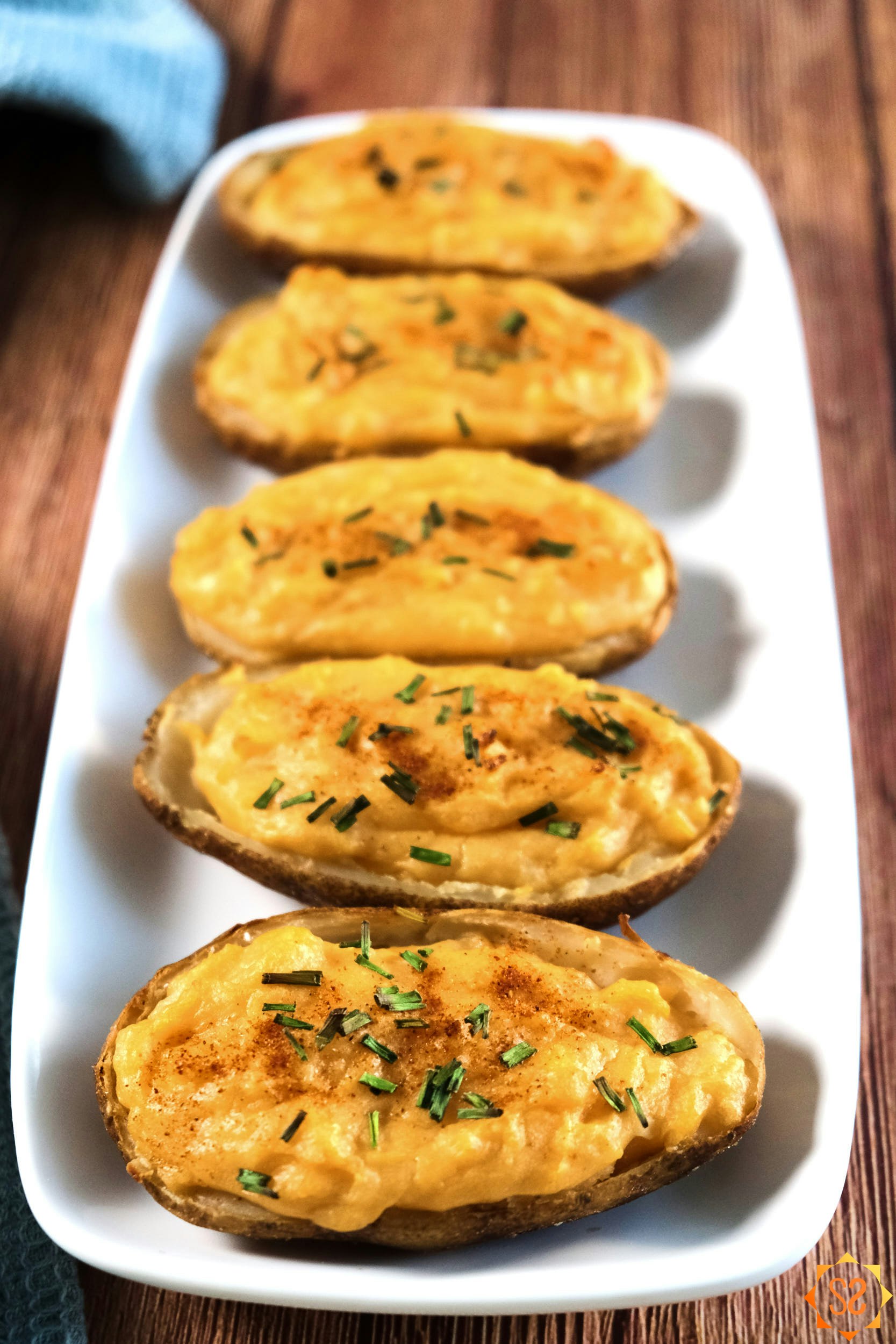 A vertical shot of a tray of vegan twice-baked potatoes