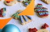 Close up of an angel-shaped sugar cookie with an ornament in the foreground