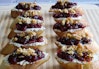 Vegan cranberry and cashew cheese crostini lined up in 2 rows