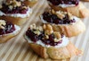 A close-up view of cranberry and cashew cheese crostini.